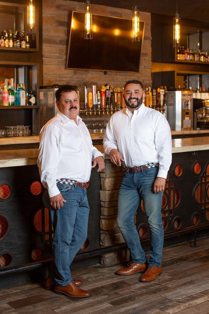 Juan and his father standing at their bar